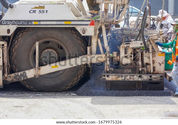 The machine is pouring asphalt for road construction in
Phitsanulok, Thailand on March 16, 2020.                           
      
