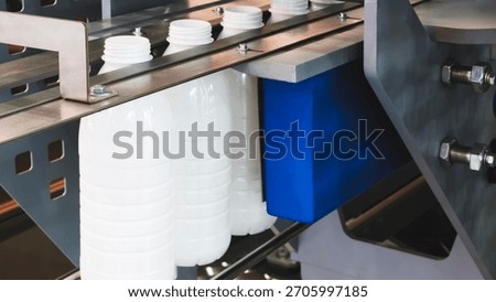 Machine for producing plastic beverage bottles using extrusion method from plastic preformed PET capsules.