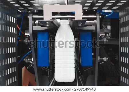 Machine for producing plastic beverage bottles using extrusion method from plastic preformed PET capsules.