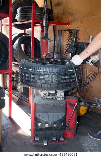 machine for removing the tire from the wheel rim\
of the car in a garage