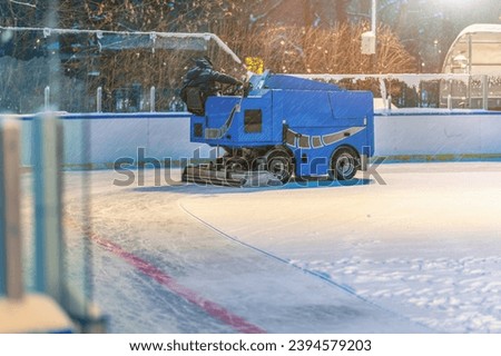 The machine for resurfacing ice. Skate rink ice cleaner. Work service process during snowfall. Ice resurfacer