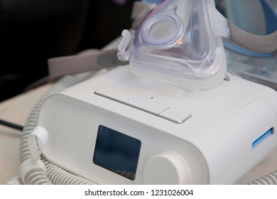  A machine for sleep apnea sits ready for use by someone who snores 