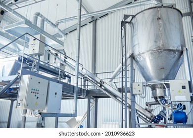 Machine for sorting and storing freshly picked wheat grains in the containers on the factory - Powered by Shutterstock