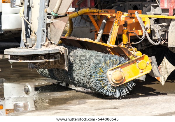 Machine sweeping dirty\
streets.