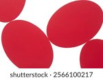 machine-cut red paper ovals arranged on a light box surface