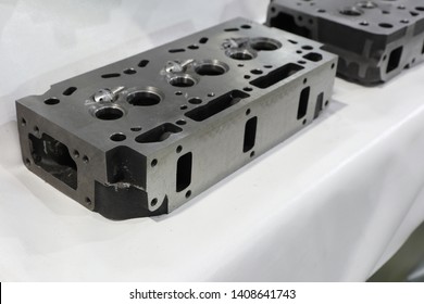 As machined head cylinder from iron casting ; close up ; industrial white background