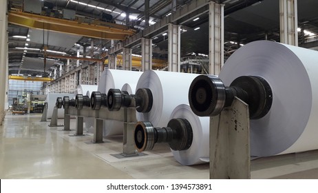 Machines for the production of paper rolls and roll of white paper in modern paper cutting machine - Shutterstock ID 1394573891