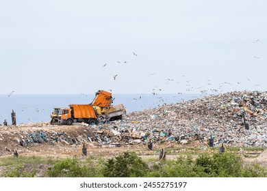 Machines are working on a dumb with sea on a background - Powered by Shutterstock