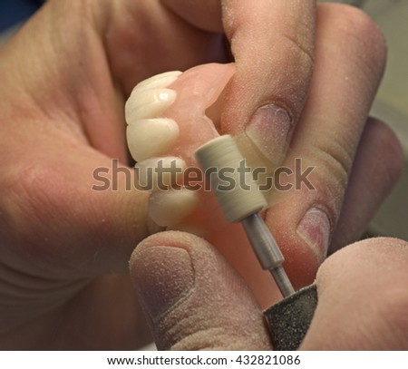 Machining dentures with a tool for processing