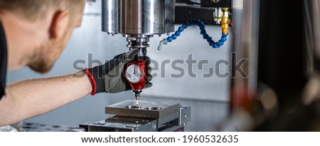 Machinist using a probe to find the centre of a hole