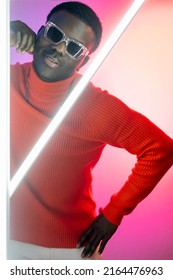 Macho man  Night life  Good mood  Fashionable style  Happy confident handsome male model posing in bright glowing neon light pink gradient 