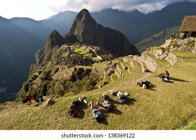 MACHU PICCHU, CUSCO, PERU - AUGUST 2: Group Of Tourists Resting After A Mountain Hike To Pre-Columbian 15th-century Inca Site Of Machu Picchu On August 2, 2011 In Cusco Region, Peru.