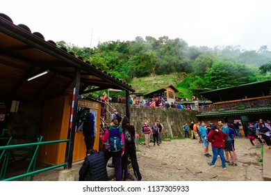 Machu Picchu, Peru - February 12, 2018: Hundreds Of People Wait To Enter Machu Picchu In Front Of The Ticket Stands And The Snak Bar