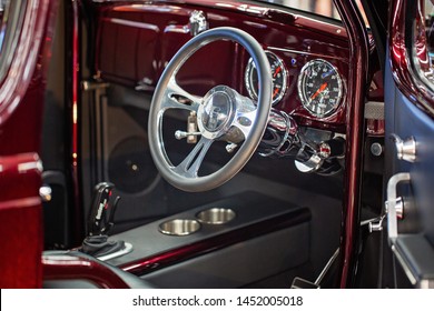 MACKAY, QUEENSLAND, AUSTRALIA - 13th July 2019: Close Up Of Steering Wheel And Interior Of Red Custom Classic Car