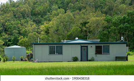 Mackay, Queensland, Australia - January 2021: A Modest Home On The Highway With A Background Of Bushland