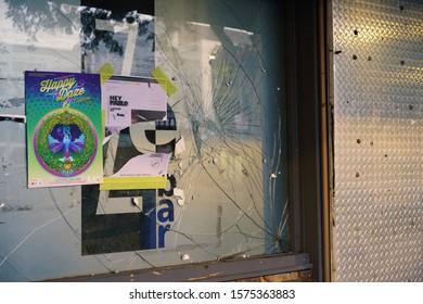 Mackay, Queensland, Australia - November 2019: Smashed Window On Exterior Of Boarded Up Night Club Out Of Business In The City Center