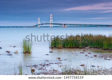 The Mackinac Bridge and the Lake Huron shoreline at sunset from Straits State Park in St. Ignace in the Upper Peninsula of Michigan