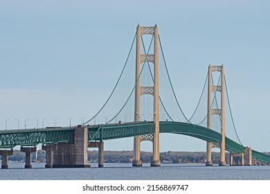 The Mackinaw Bridge is illuminated by the evening sun and carries Interstate 75 connecting Michigan's Upper and Lower Peninsulas. It is one of the longest suspension bridges in the world.