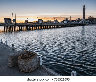 MacMillan Pier And The Pilgrim Monument Are Set Against Sunset Skies In This Provincetown Winter Scene.