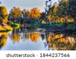 Macquarie river flowing in Dubbo city of Great Western plains in Australia - scenic landscape at sunset.