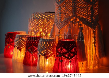 Macrame hand woven with cord red and white lanterns glowing