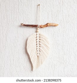 Macrame leaf wall hanging in natural color on the wooden stick. Cotton rope decor macrame to make your room more cozy and unique. Copy space