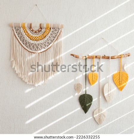 Macrame leaves wall hanging in yellow, white, green and natural color on the wooden stick. Cotton rope decor macrame to make your room more cozy and unique. Close up ストックフォト © 