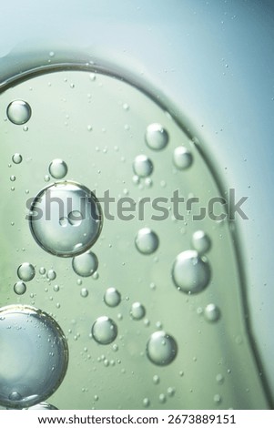 A macro abstract image of oil bubbles suspended in clear liquid, evoking facial serum texture. Ideal for beauty, cosmetic, and skincare-themed visuals.