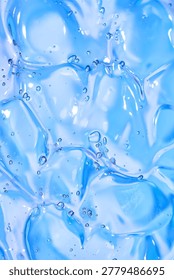 Macro abstract texture of blue transparent gel with many bubbles, glossy cosmetic background for skincare, hydration, wellness and beauty product design. Full frame 