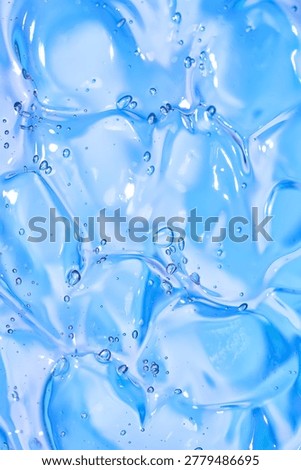 Macro abstract texture of blue transparent gel with many bubbles, glossy cosmetic background for skincare, hydration, wellness and beauty product design. Full frame 