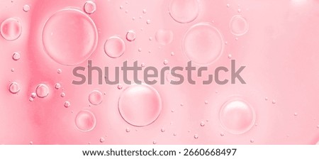 Macro abstract texture with multiple pink liquid bubbles on a soft gradient background, close-up view. 