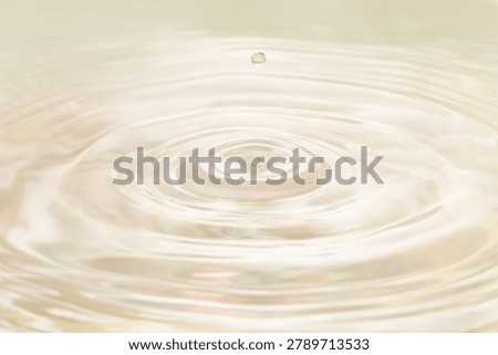 Macro background material of water droplets falling onto a water surface for beauty purposes.
