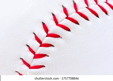 Macro of a baseball surface with stitching.