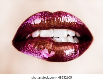 macro of beautiful lips with purple and gold lipstick