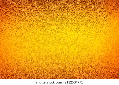 macro beer drink,Water drops background,Close up drops of a Ice Cold Pint of Beer- condensation. The background is clear with the emphasis on water drops on yellow-golden background. - Shutterstock ID 2112504971