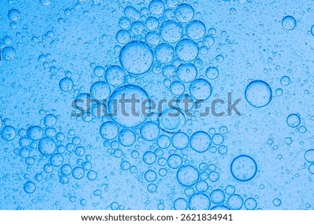 Macro blue science experiment bubble texture,A close-up of a blue liquid with bubbles in a petri dish, showcasing a captivating microscopic view. ideal for concepts of science, medicine, research, and