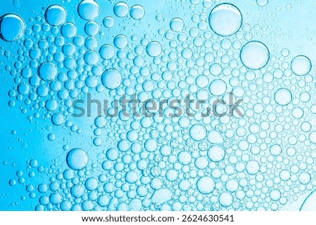 Macro blue science experiment bubble texture,A close-up of a blue liquid with bubbles in a petri dish, showcasing a captivating microscopic view. ideal for concepts of science, medicine, research,