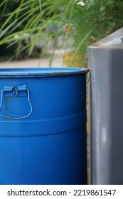 Macro Blue Trash Bin Beside A Wall