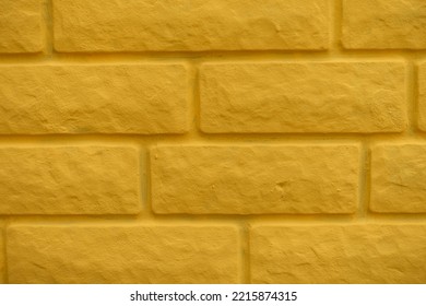 Macro Of Bright Yellow Painted Brick Veneer Wall