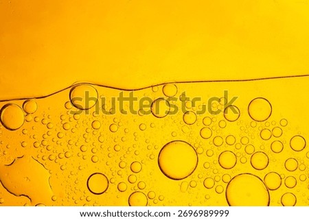 Macro bubble texture, yellow,Macro close up yellow oil bubble texture,Gold Oil bubbles close up. circles of orange water macro. abstract shiny yellow background.