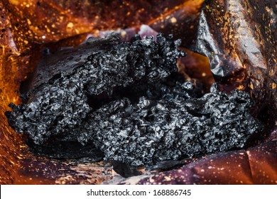 Macro Of Burnt Paper Bag With Melted And Burnt Popcorn In Microwave Oven, After The Explosion And Fire 