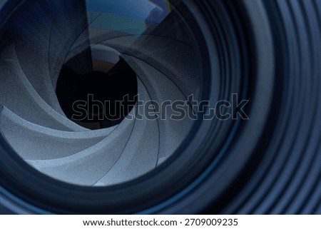 Macro camera lens,The diaphragm of old camera lens aperture with warm light bokeh. Selective focus with shallow depth of field. Vintage color tone filtered. Photo or video camera lens with light
