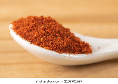 Macro of cayenne pepper in a small white spoon
