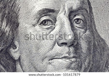 Macro close up of Ben Franklin's face on the US $100 dollar bill.