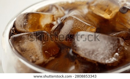 Macro Close Up of cola bubbles and ice cubes background
