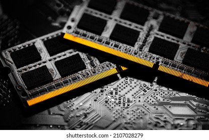 Macro Close up of computer RAM chip and motherboard on dark background - Shutterstock ID 2107028279