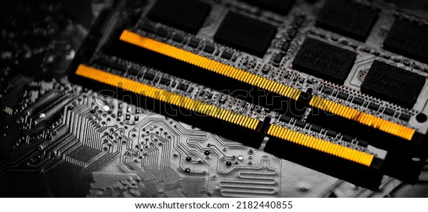 Macro Close up of computer RAM chip and\
motherboard on dark\
background