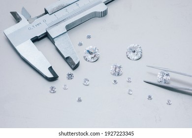 Macro close up of experienced goldsmith sorting high quality diamonds, selecting them to make precious jewels in workshop.Concept of jewelry,luxury,goldsmith, diamonds, brilliance.