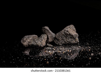 Macro Close Up Image Of Raw Material Platinum And Chrome Ore Rock Isolated On Black Reflective Background