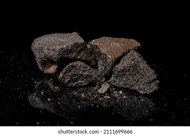 Macro Close Up Image Of Raw Material Platinum And Chrome Ore Rock Isolated On Black Reflective Background